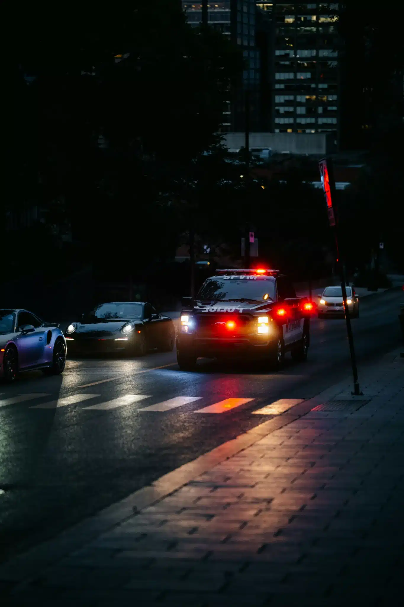 Emergency vehicle with flashing lights on a dark street at night