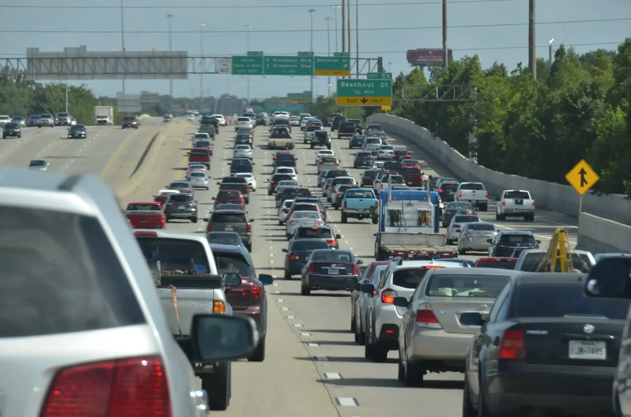 Dense stop-and-go traffic on a Texas freeway with brake lights on