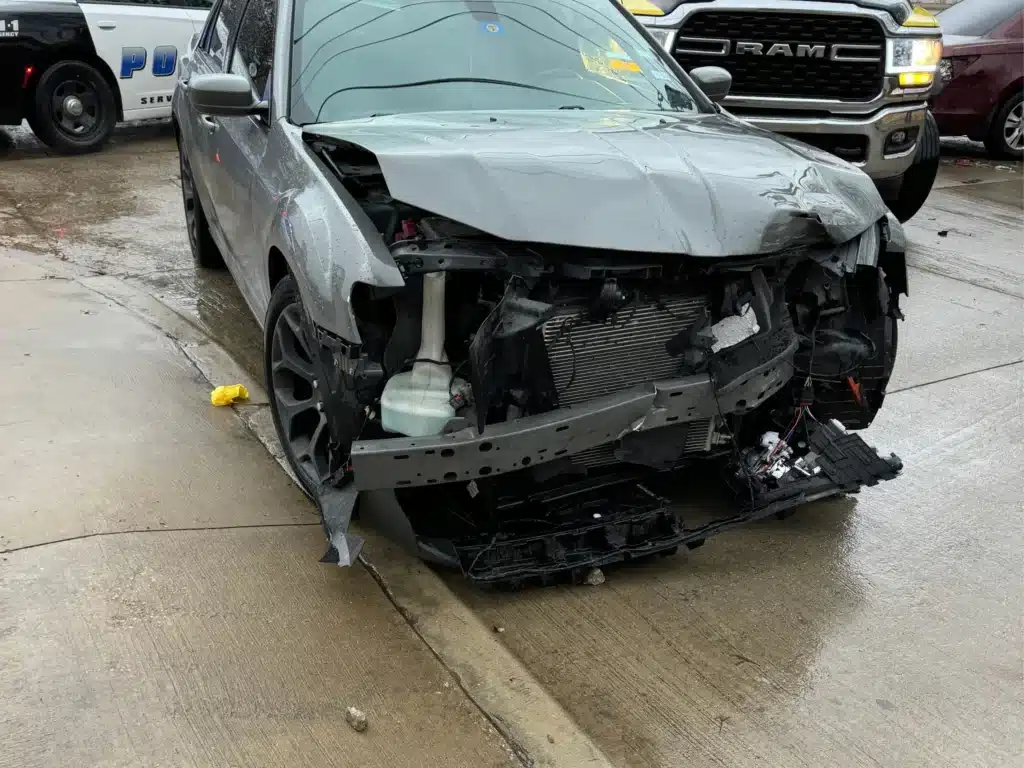 The crushed front end of our client's Chrysler 300 after a driver failed to yield at a stop sign on Abrams Road in Dallas