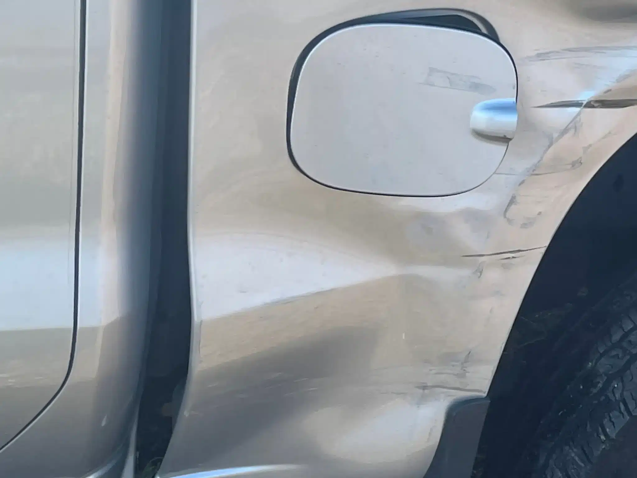 Creases and scrape marks around the fuel door of the Silverado