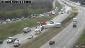 TxDOT traffic camera view of northbound I-45 near Parker Hill Road, a white tractor trailer lying on its side across the lanes while wreckers and emergency crews work the scene