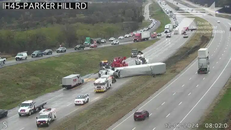 TxDOT traffic camera view of northbound I-45 near Parker Hill Road, a white tractor trailer lying on its side across the lanes while wreckers and emergency crews work the scene