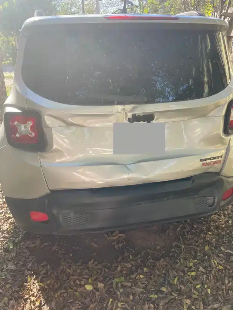 La parte trasera del SUV plateado de nuestra clienta despu&eacute;s del accidente en cadena en Uvalde, con el port&oacute;n y la defensa hundidos